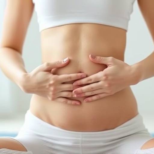 Close-up of a person's hands gently placed on their abdomen during a breathing exercise in a tranquil setting
